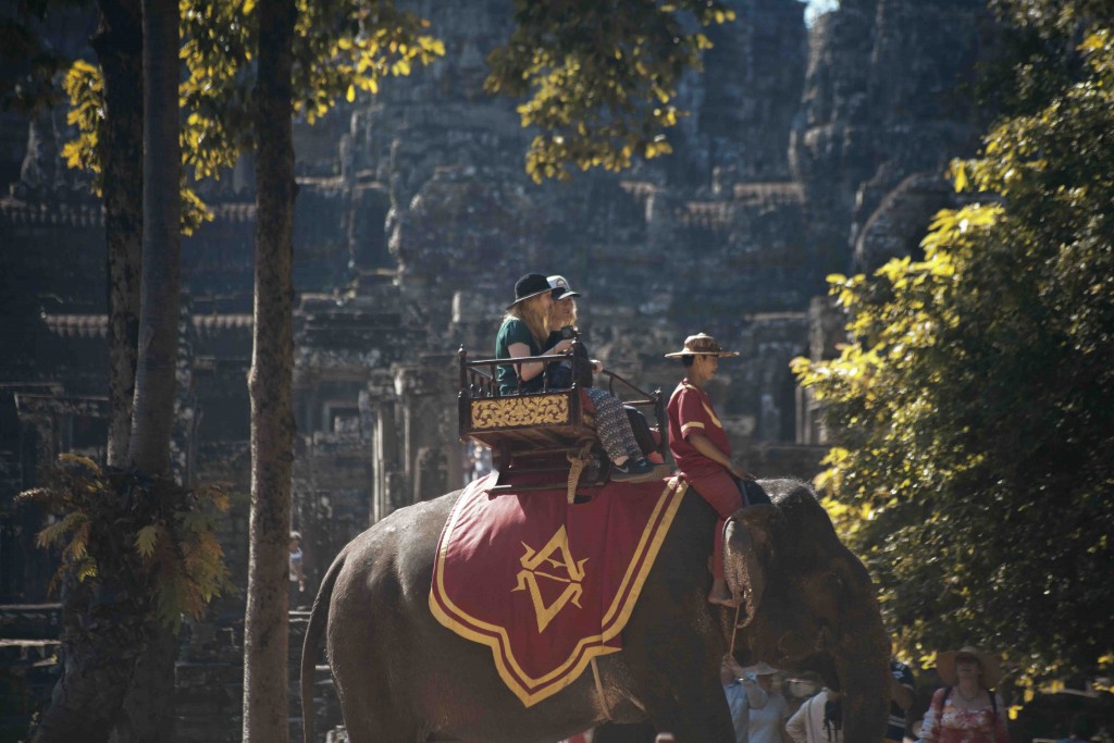 Tourists riding an elephant at Bayon, Angkor Thom